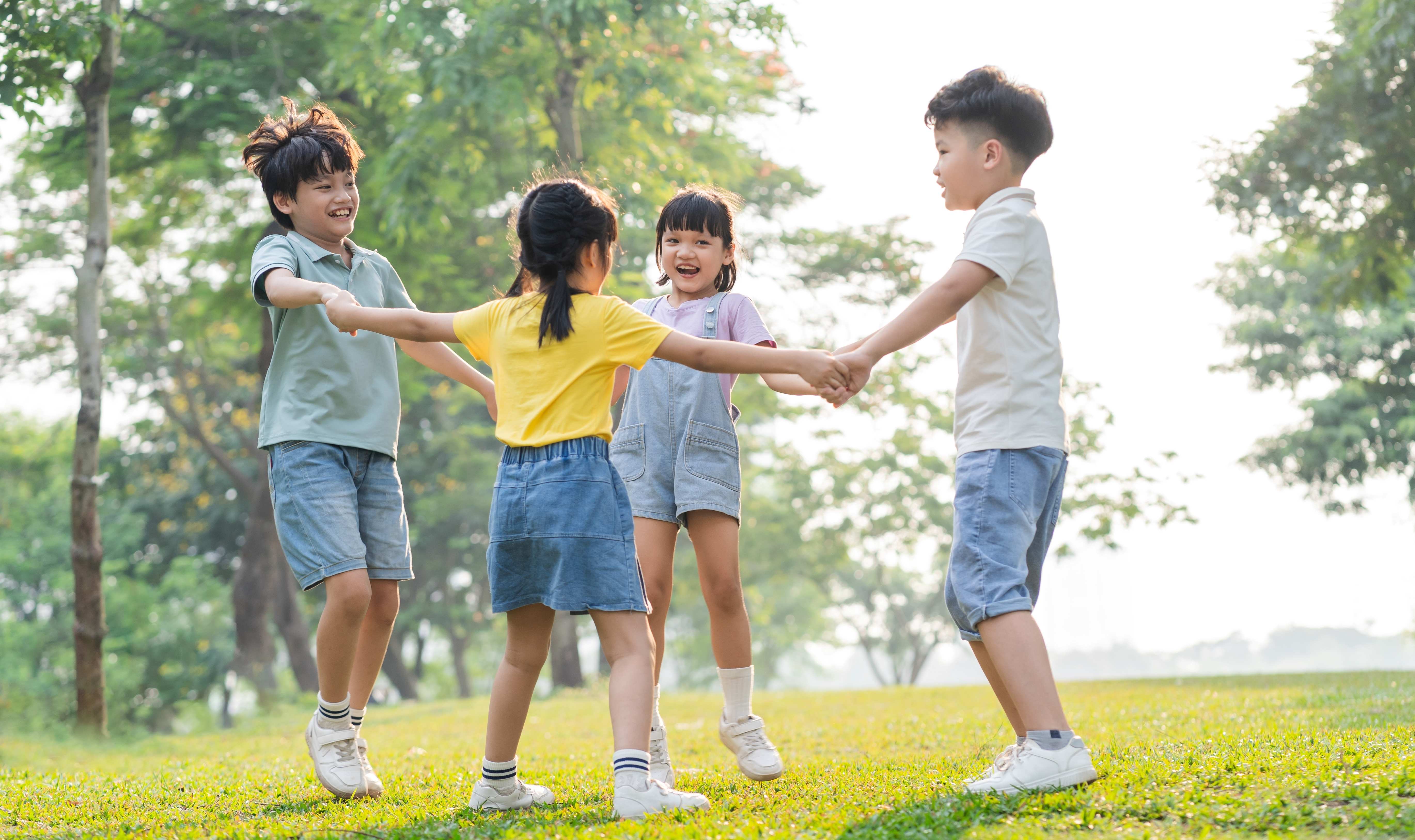 Children in a circle playing outside 