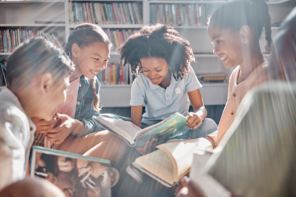 Children sitting on the floor reading - various ethnicities 